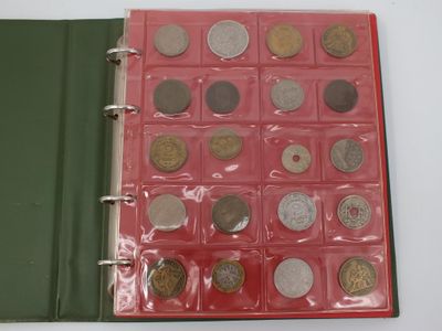 a red binder with a lot of coins in it