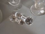 bottles and glasses are sitting on a table next to each other