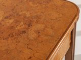 a close up of a wooden table with a drawer on it