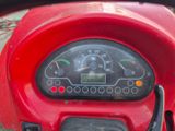a close up of a red motorcycle with a speedometer