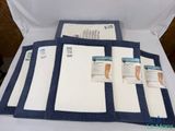 a picture of a bed with a blue and white blanket on it