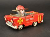 a red toy truck with a fire chief on it
