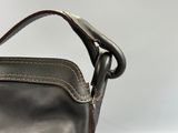 a black purse with a brown handle on a white background
