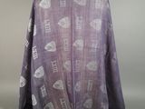 the back of a purple shawl with a pattern of birds on it