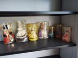 a shelf that has many different types of dolls on it