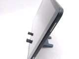 a tablet computer sitting on a stand on a white surface