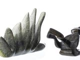 two figurines that are sitting next to each other