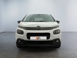 the front of a white citrole parked in a white room