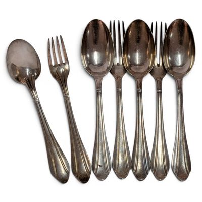 six spoons and a fork are lined up on a white surface