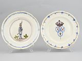 pair of blue and white plates with figures on them