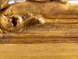 a gold statue of a cat laying on top of a table