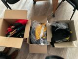 two boxes with clothes and umbrellas in them on the floor
