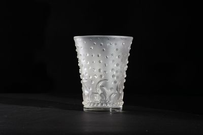 a glass cup that is sitting on a table