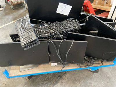 a lot of computer equipment on a cart in the warehouse