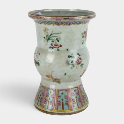 a white vase with a floral design on it