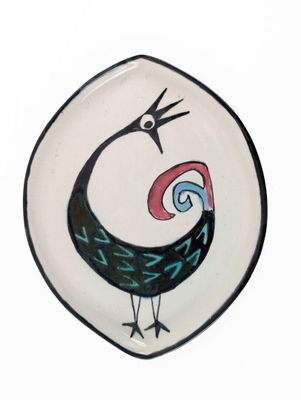 a plate with a bird painted on it on a white background