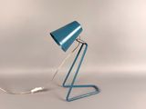 an image of a blue table lamp on a white surface