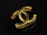 a close up of a gold ring on a black surface