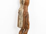 an old wooden statue of a man with a hat on his head