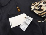 a bag and a tag on the back of a black jacket