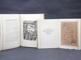 three open books with drawings on them sitting on a table