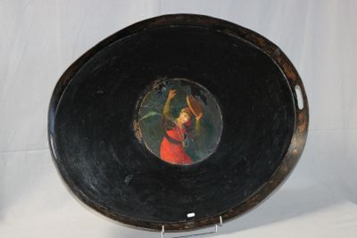 a painting of a woman in a red dress on a black plate