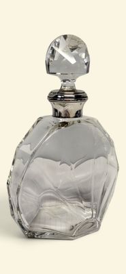 a clear glass bottle with a silver top on a white surface