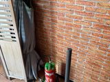 a fire extinguisher next to a brick wall and a fire hydrant