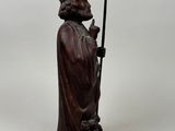 an image of a statue of a man holding a staff