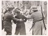 a black and white photo of a group of men shaking hands