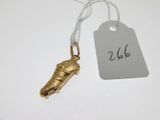 a gold charm with a tag attached to it