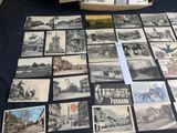 a lot of old black and white photos on the table