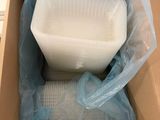 a plastic container in a cardboard box with a plastic lid