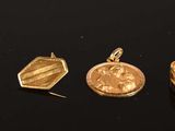 five different types of gold rings on a black surface