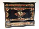 an image of a black and gold chest with a bird on it