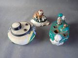 three ceramic objects that are sitting on a table