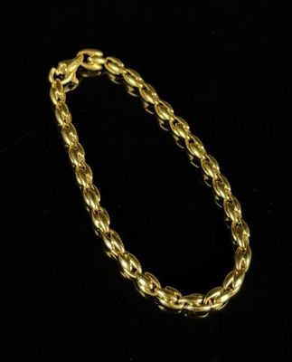 a gold chain bracelet on a black background