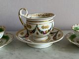 three cups and saucers sitting on a table