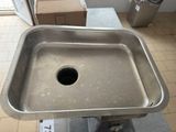 a metal sink with a hole in the middle of it