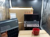 many boxes in the back of a truck with a coffee cup on it