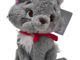 a gray stuffed cat with a red bow on it ' s neck