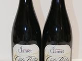 two bottles of wine sitting next to each other on a table