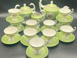 many cups and saucers sitting on a table