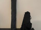 two black umbrellas on a black table next to a white wall