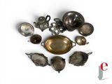 a lot of antique silverware on a white surface