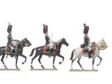 three figurines of men riding on horses on a white background