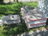 a pile of boxes sitting on the grass next to a building
