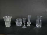 five different glass vases on a black table