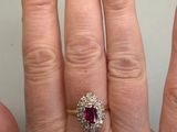 someone is holding their hand up with a ring on it