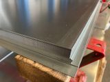 a close up of a stack of metal sheets sitting on top of a table